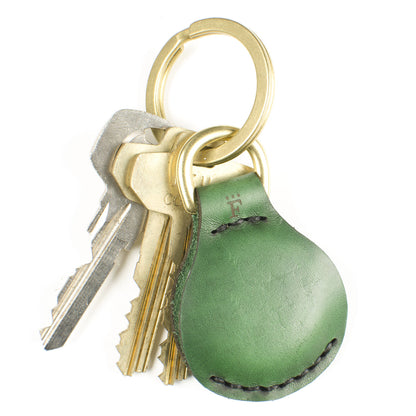 AirTag FFFob LayFlat — hero shot showing flat Horween leather AirTag holder with key ring options